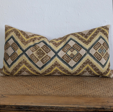 Simon Dowry pillow in brown, yellow, pink and blue